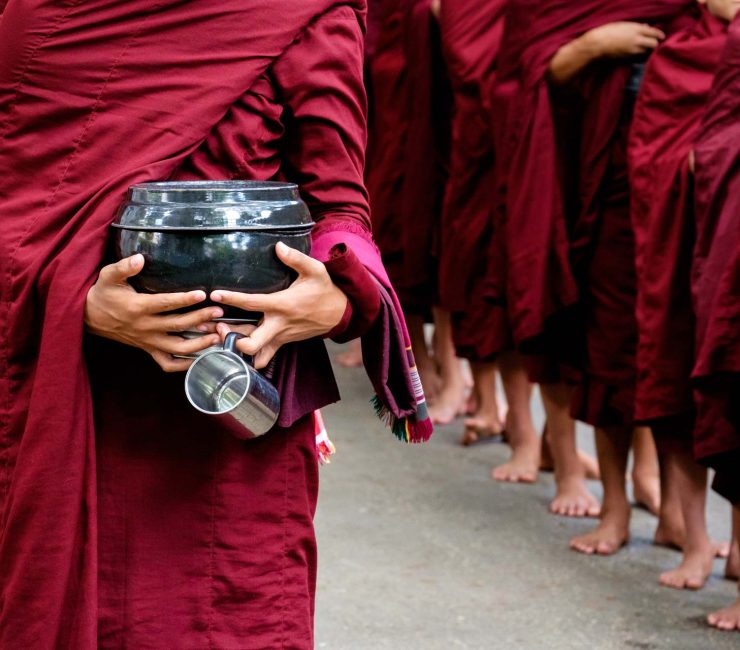 detail-of-buddhist-monks-crowd-and-person-holding-PKCY67V.jpg